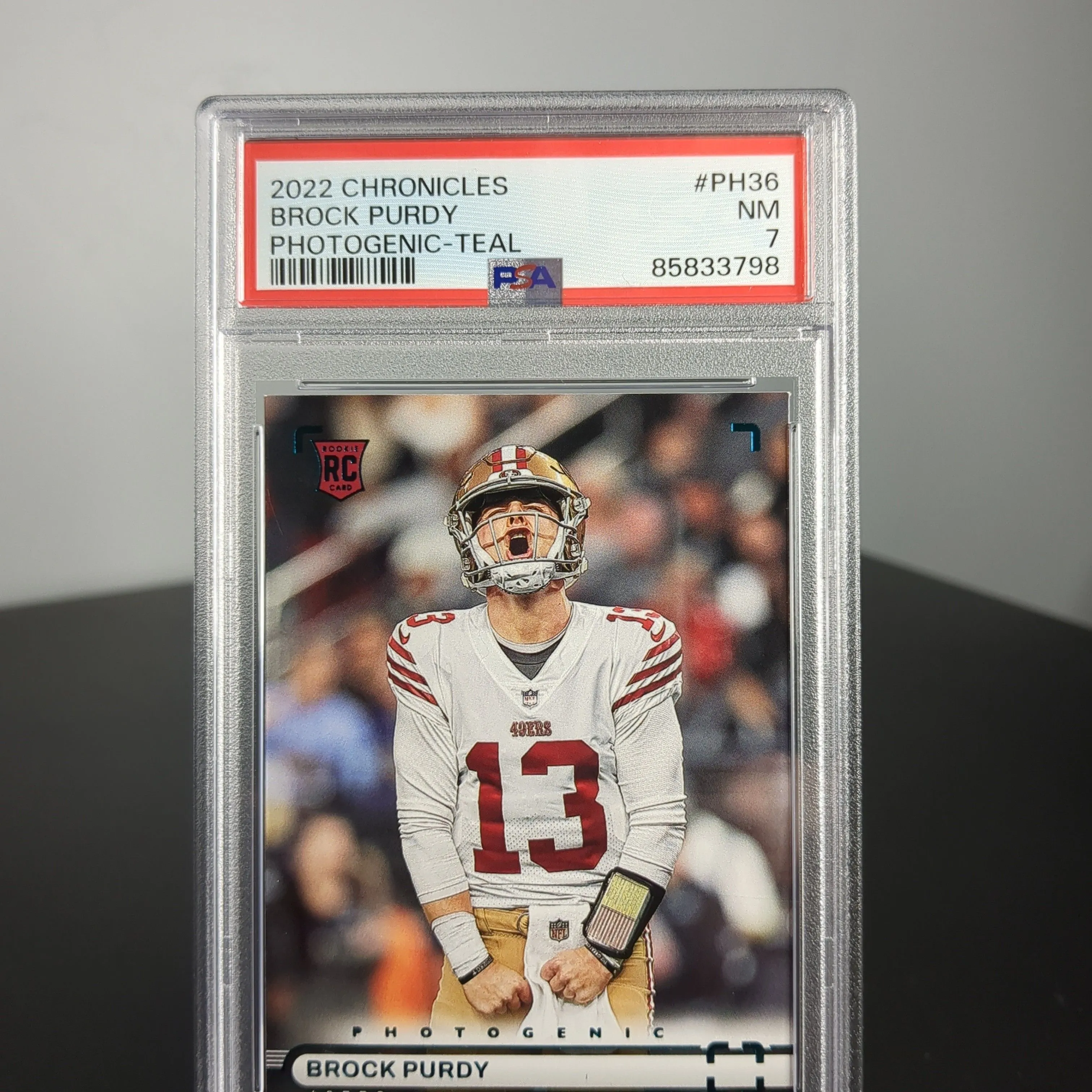 Product image for 2022 Panini Chronicles Photogenic Brock Purdy PH36 Photogenic-Teal PSA NM 7