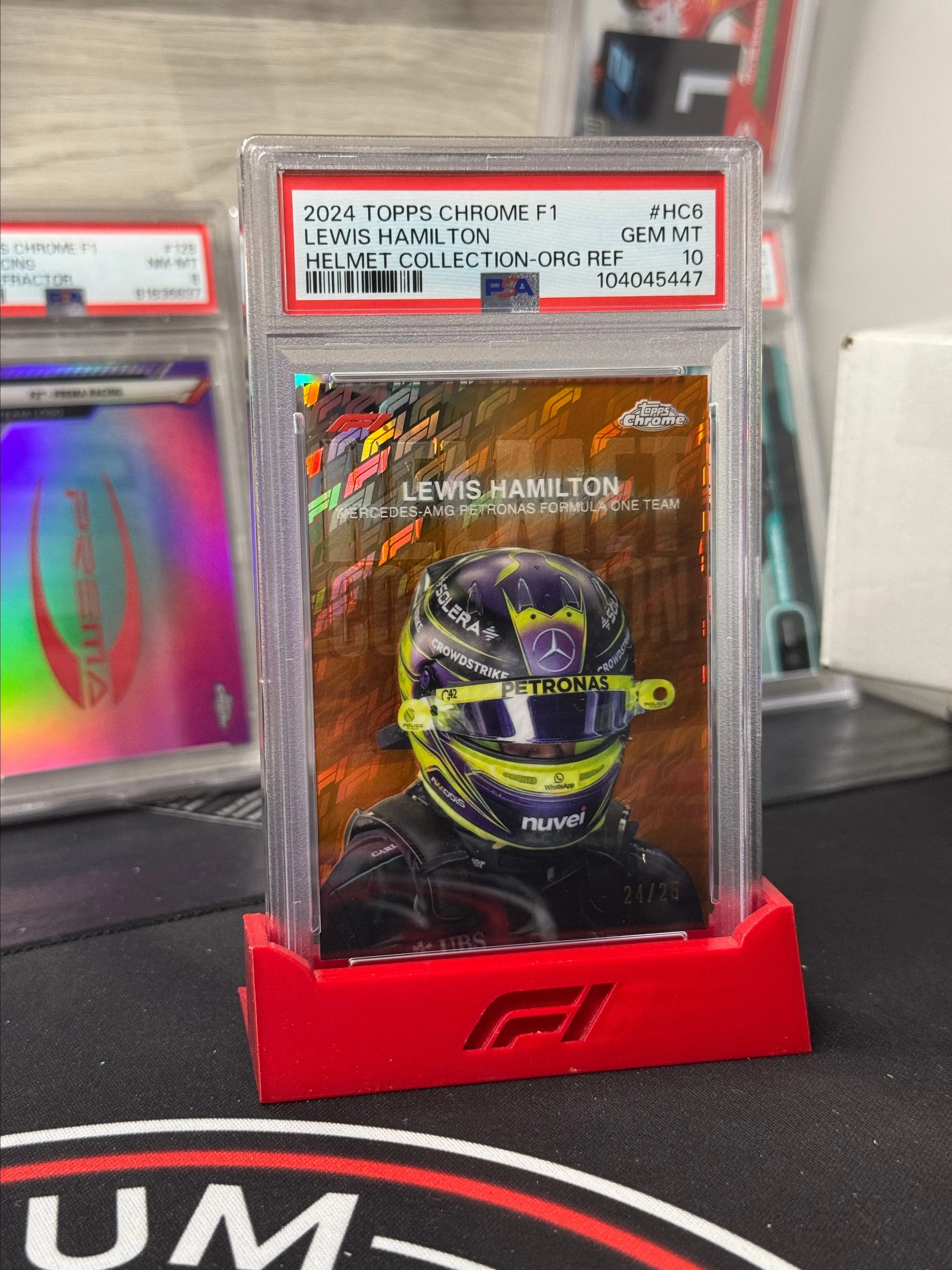 Product image for 2024 Topps Chrome Formula 1 Logofractor - Lewis Helmet Orange Helmet /25 PSA 10