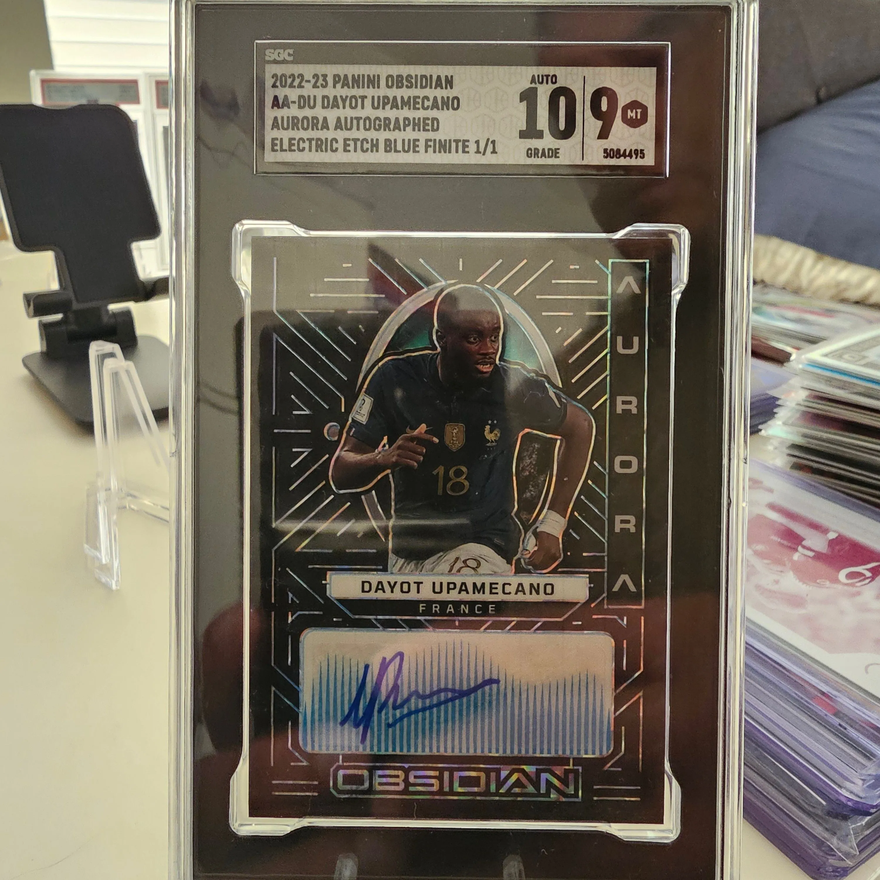 Product image for 2022-23 Panini Obsidian Aurora Dayot Upamecano Auto 1/1 SGC 9 Auto 10