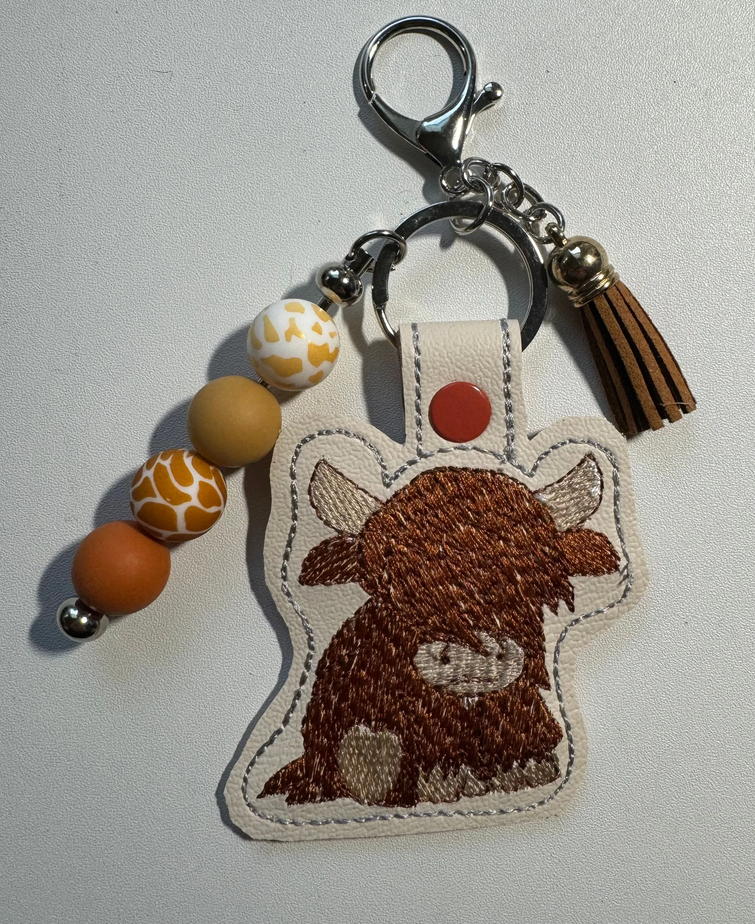 Product image for Highland cow embroidered keychain with beads