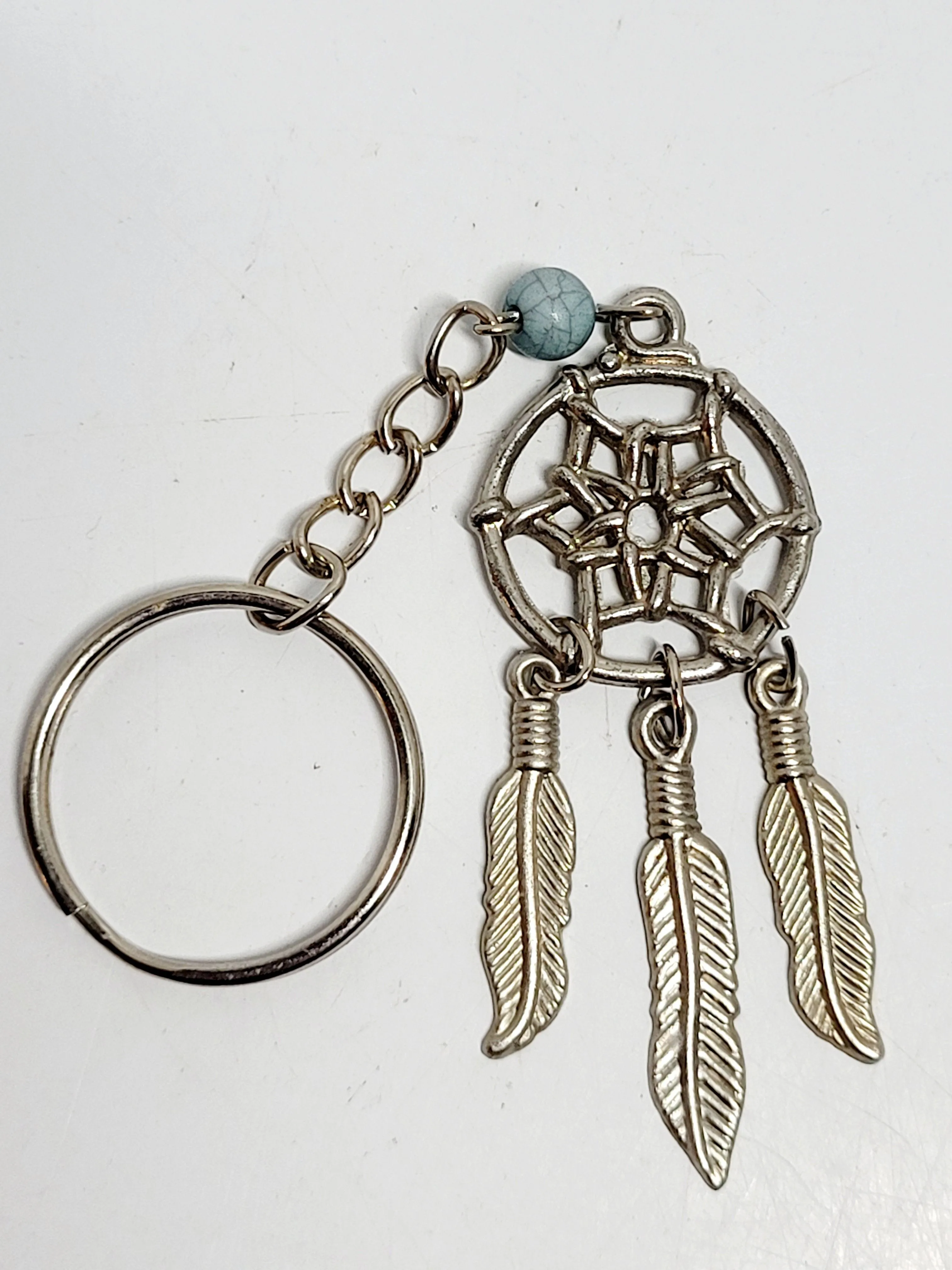 Product image for 4" Dream Catcher Key Chain Feather Charm Bag Silver-toned Southwestern Jewelry.
The image shows a ke
