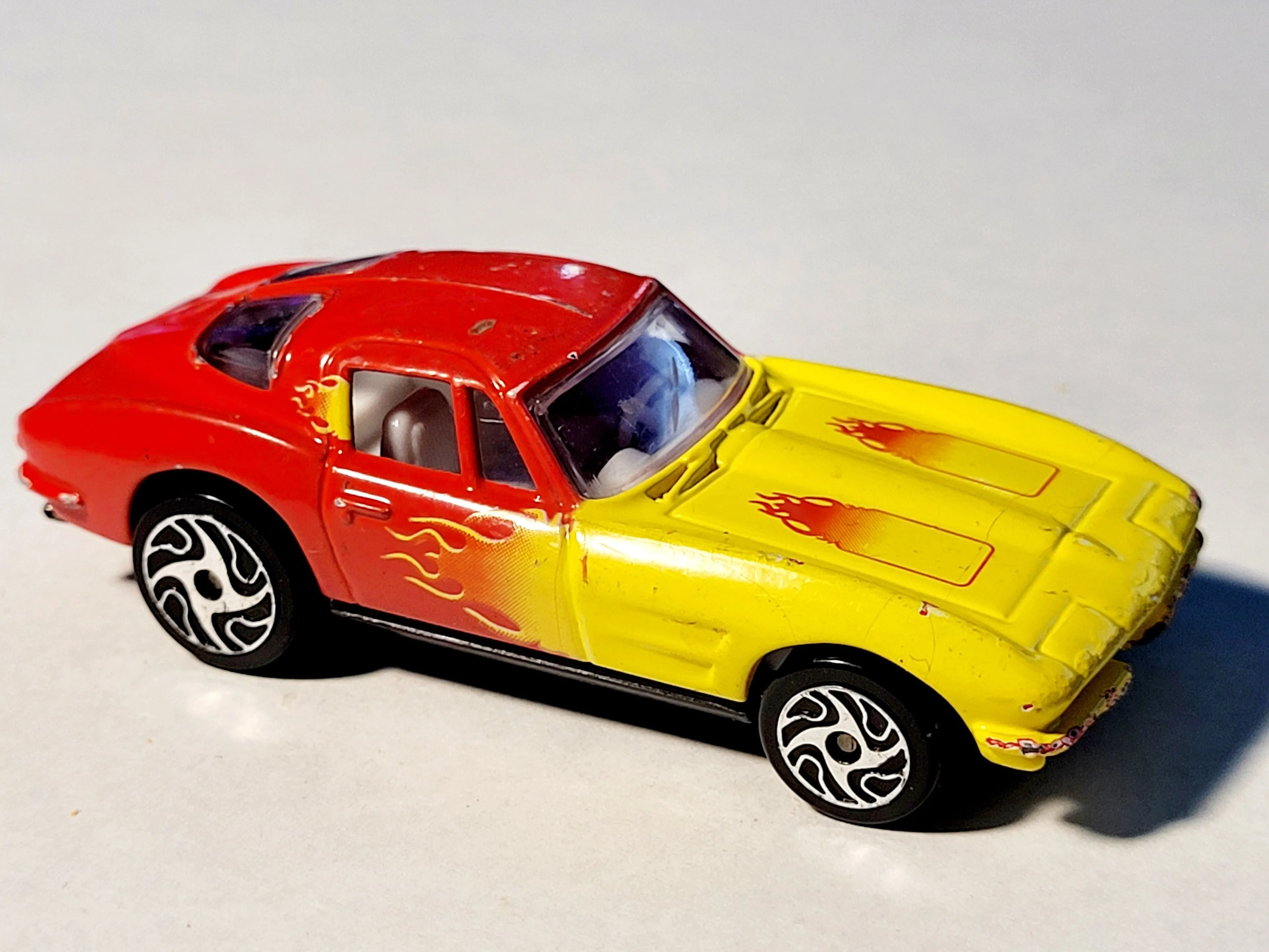 Product image for 1998 Racing Champions (1963) Vintage Corvette Coupe Red/Yellow Die-Cast 1:64 Car. The car in the ima