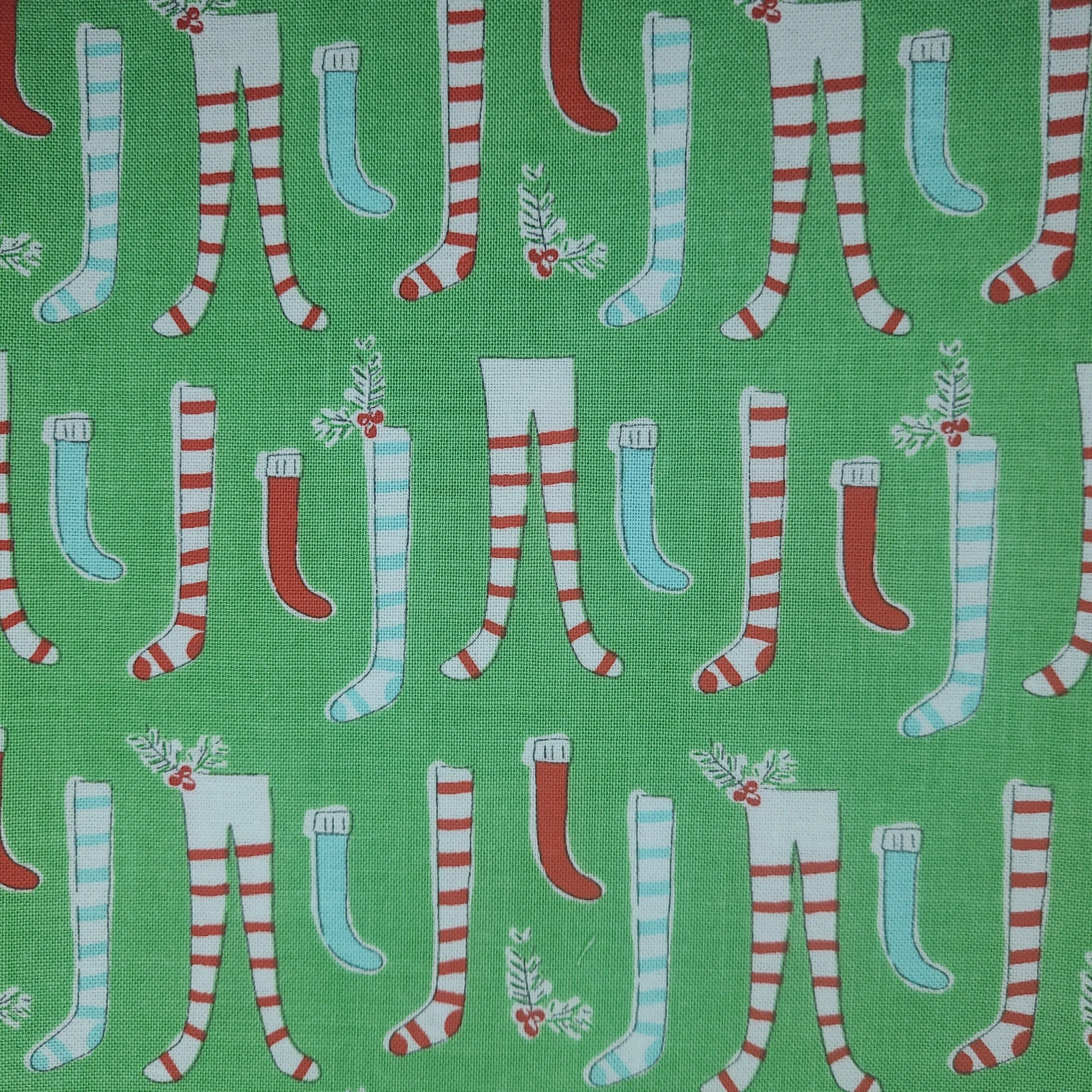 Product image for 1/2 yard green stocking holiday fabric. 1/2 yard. 100% cotton. Riley blake fabric.