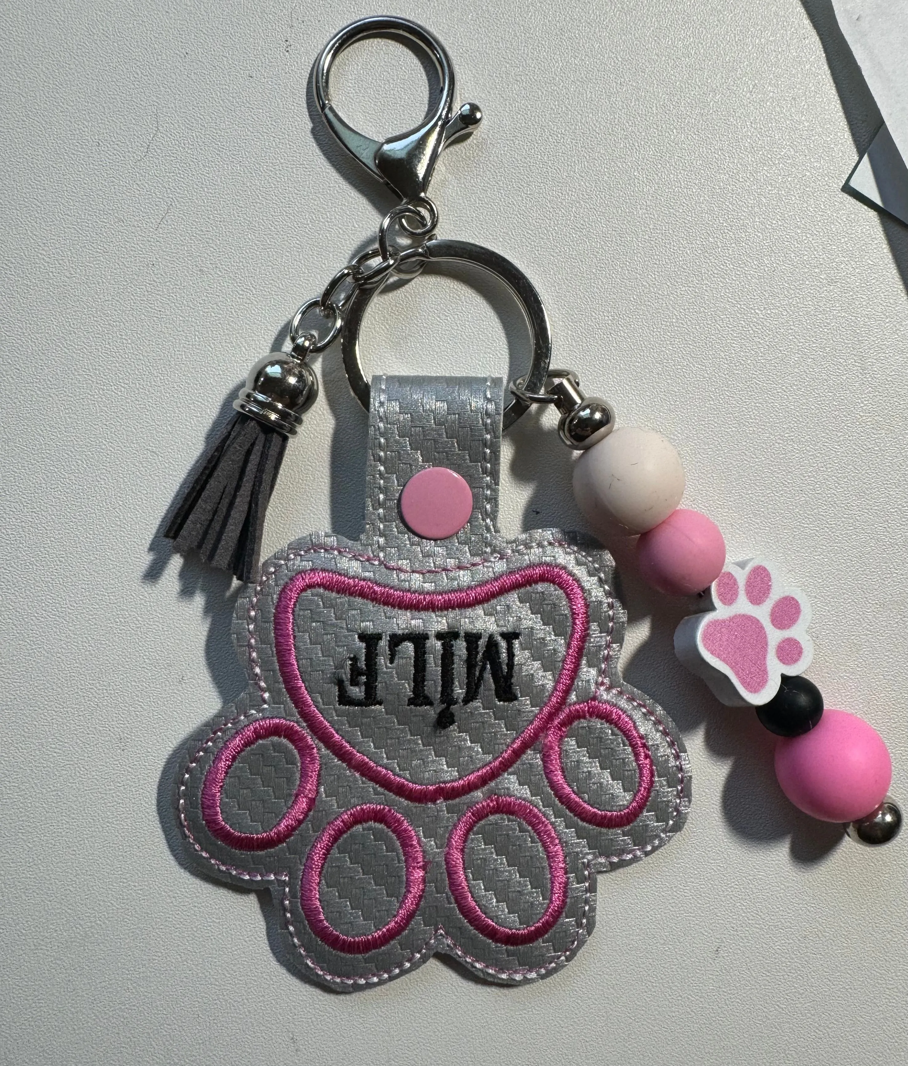Product image for Paw print embroidered keychain with beads