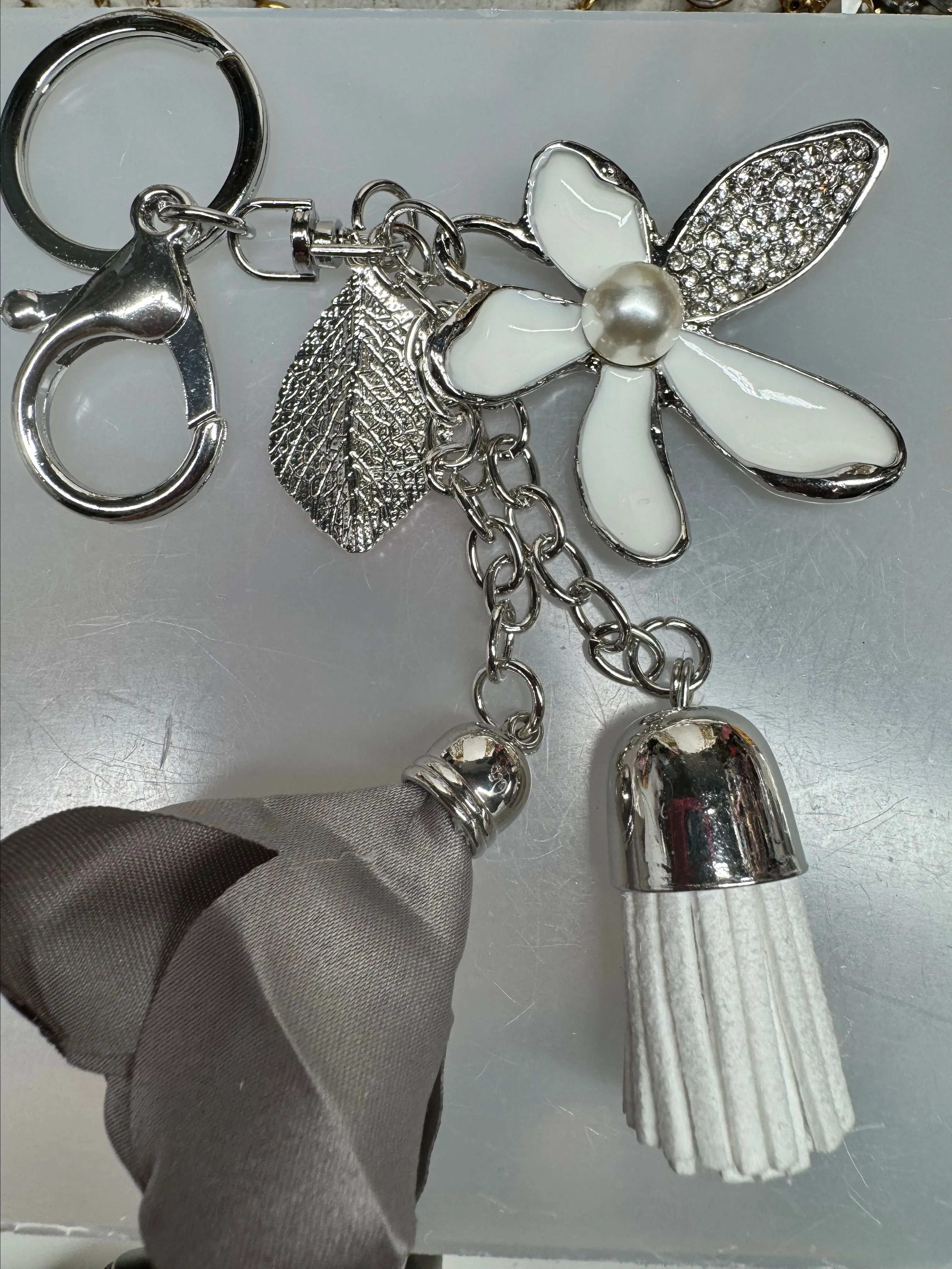 Product image for 13 bag charm keychain with fringe and gray flower