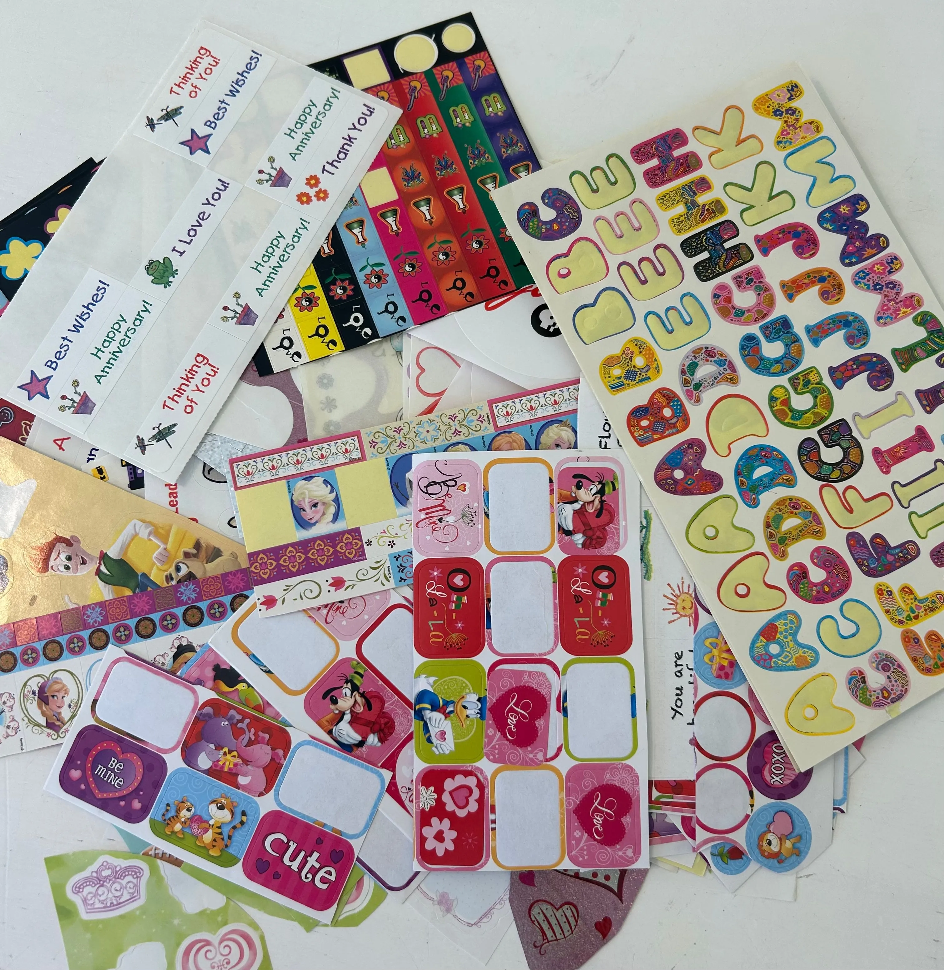 Product image for Envelope filled with tons of sticker sheets with some being used.