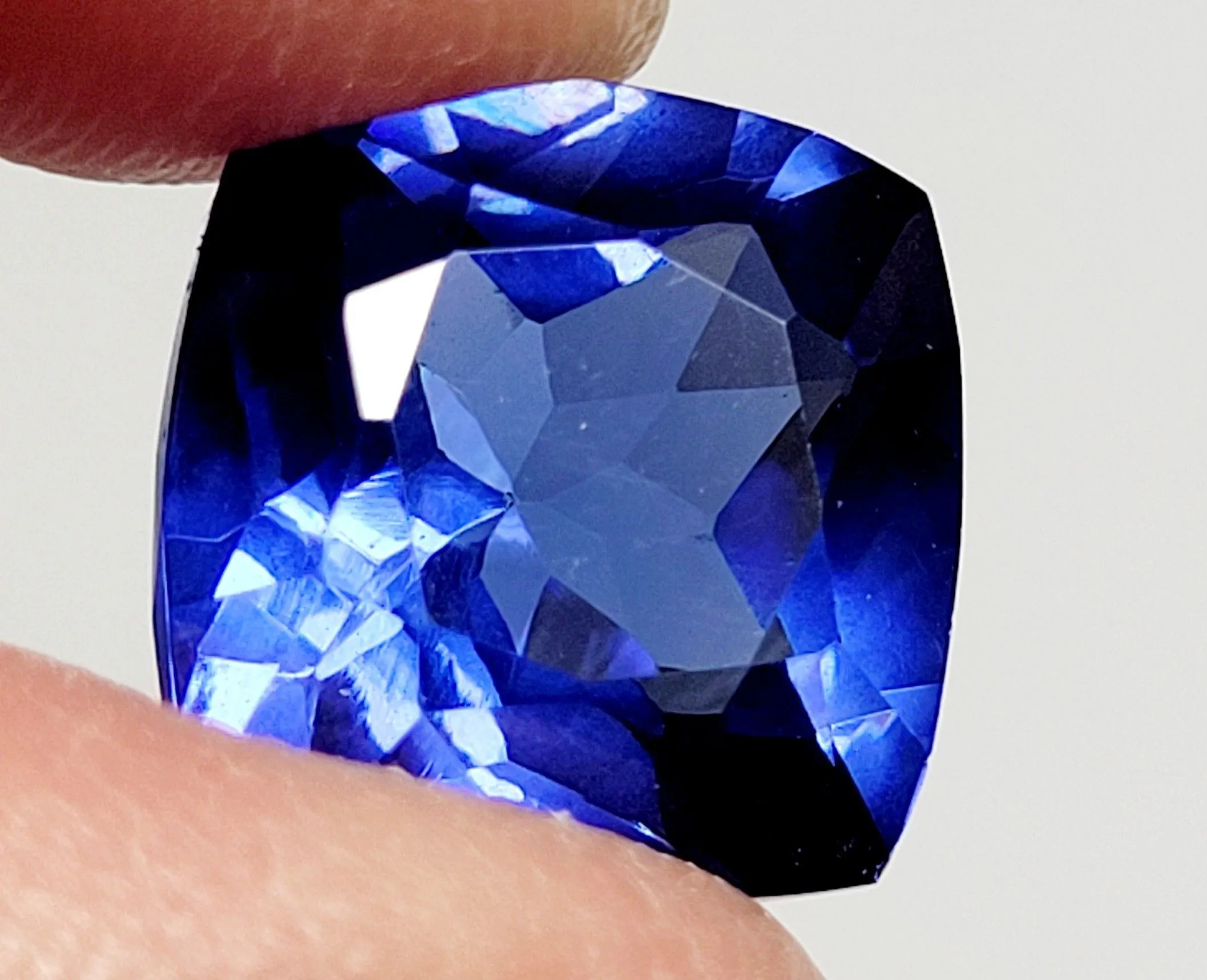 Product image for This 10.52 Ct loose blue Zoisite Tanzanite-like gemstone is a transparent, cushion-cut gemstone that