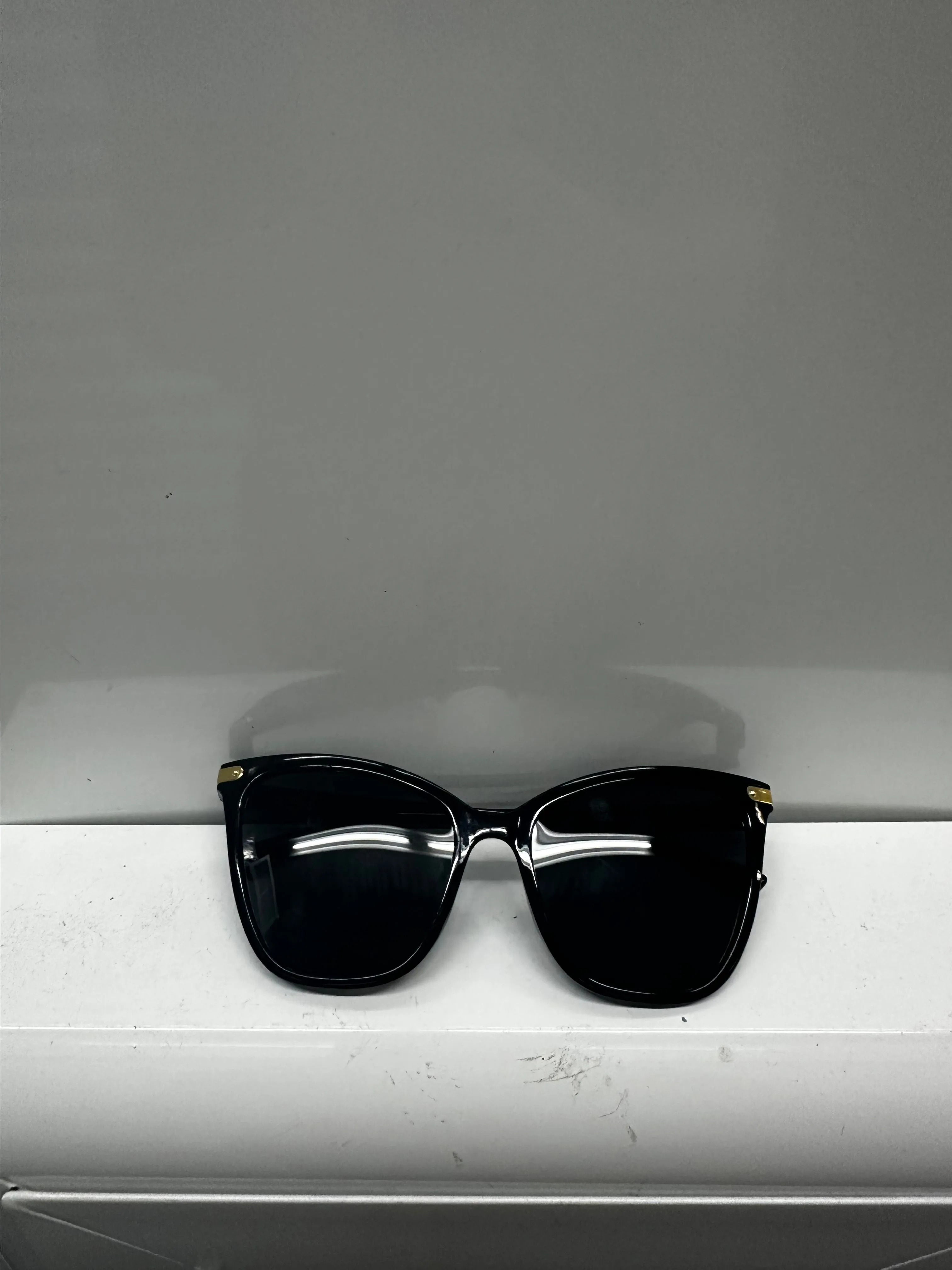 Product image for Stylish black sunglasses with gold accents.