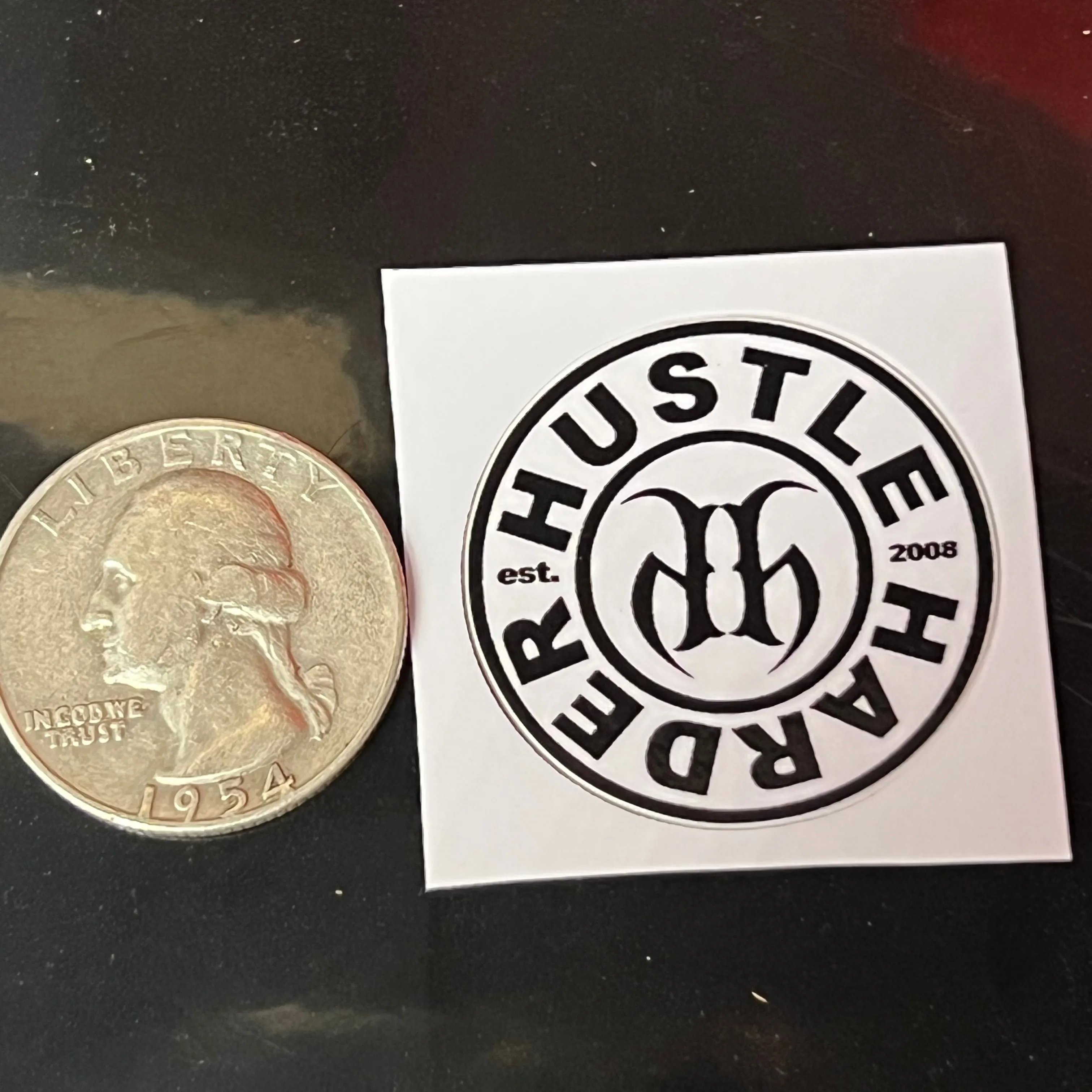 Product image for 1” Hustle Harder Round Sticker (Quarter shown for size comparison scale)