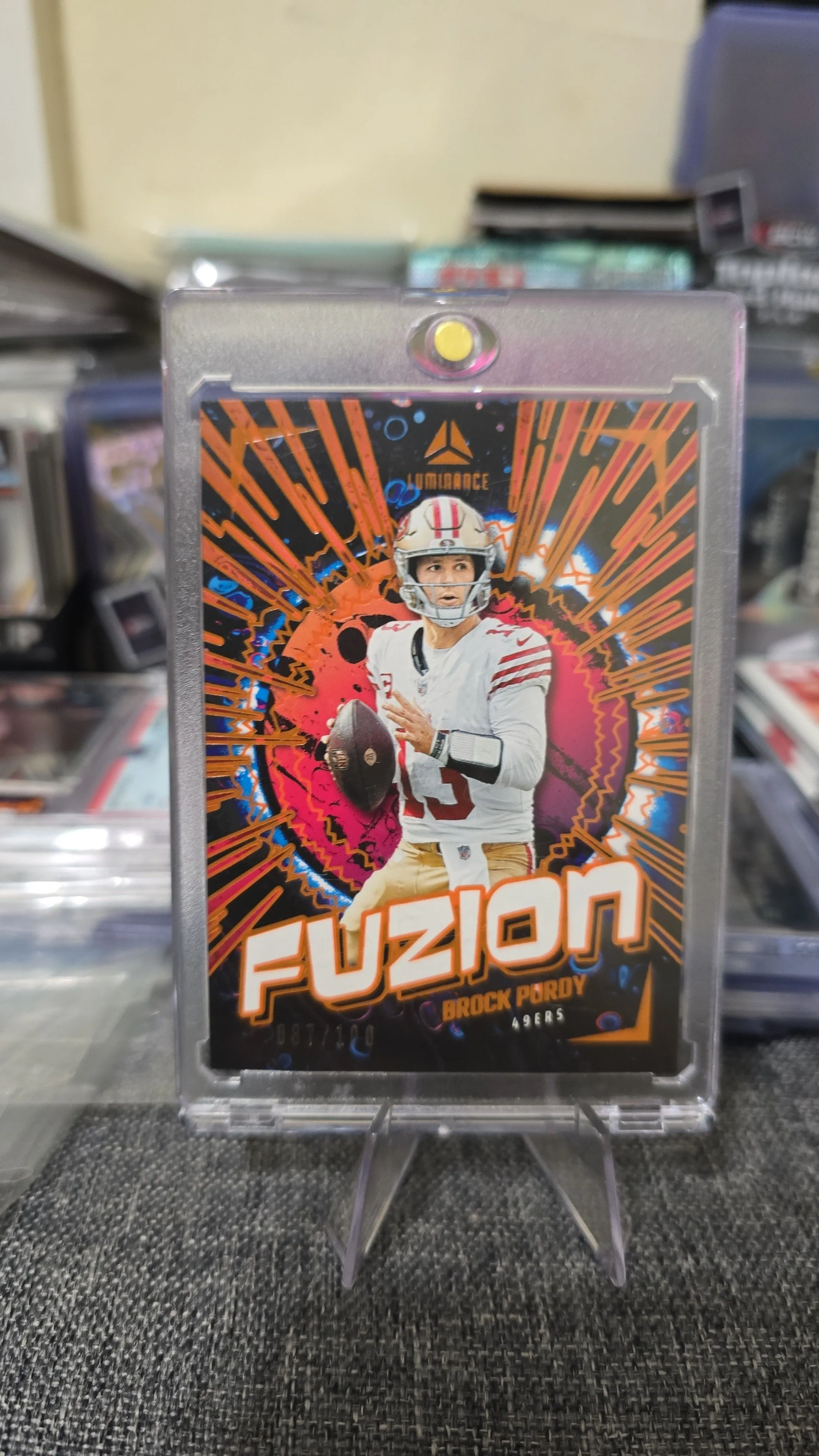 Product image for 2024 Luminance Football Fuzion Brock Purdy # FUZ-BPY Orange /100 49ers
