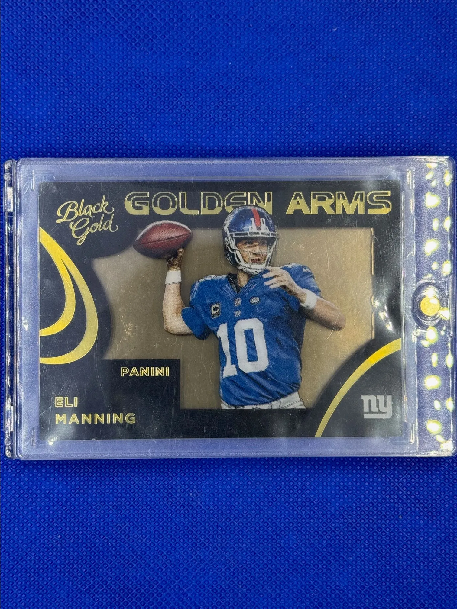 Product image for 2015 Panini Black Gold Golden Arms Gold Foil 03/49 Eli Manning #GA-10