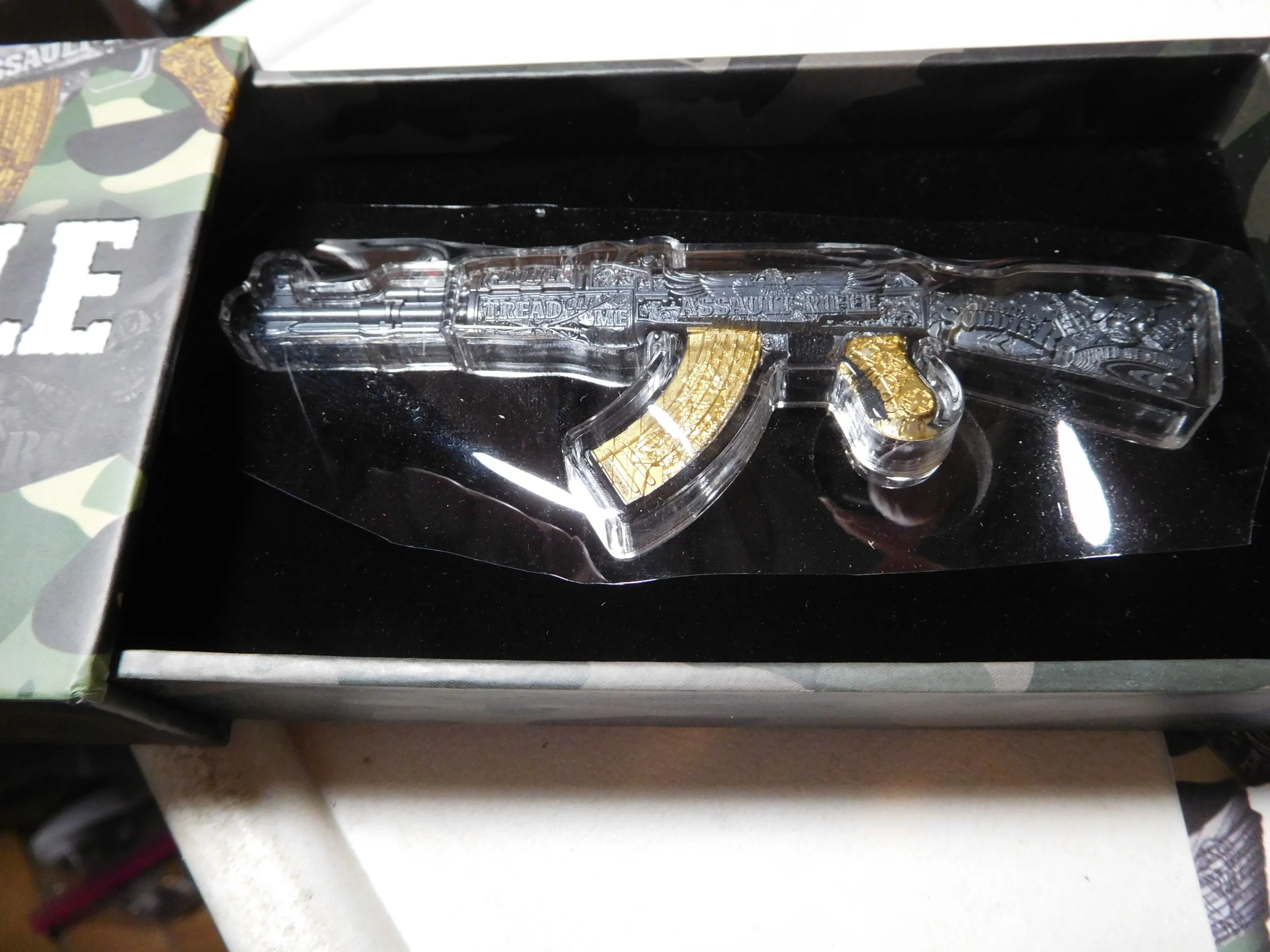 Product image for 2024 Chad 2 oz Assault Rifle Black & Gold Shaped Coin