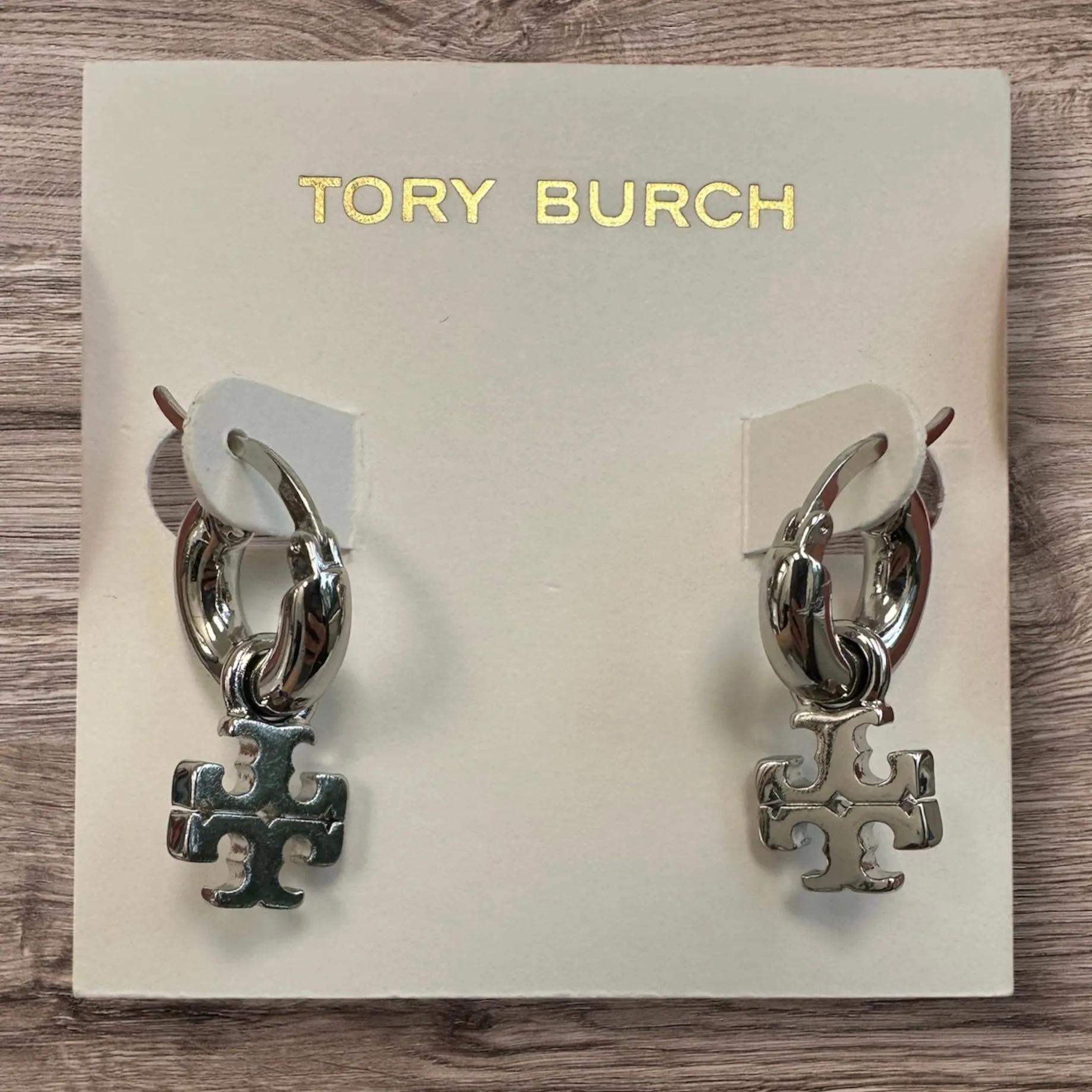 Product image for New Tory Burch Kira Logo Drop Huggie Hoop Earrings Silver on TB card