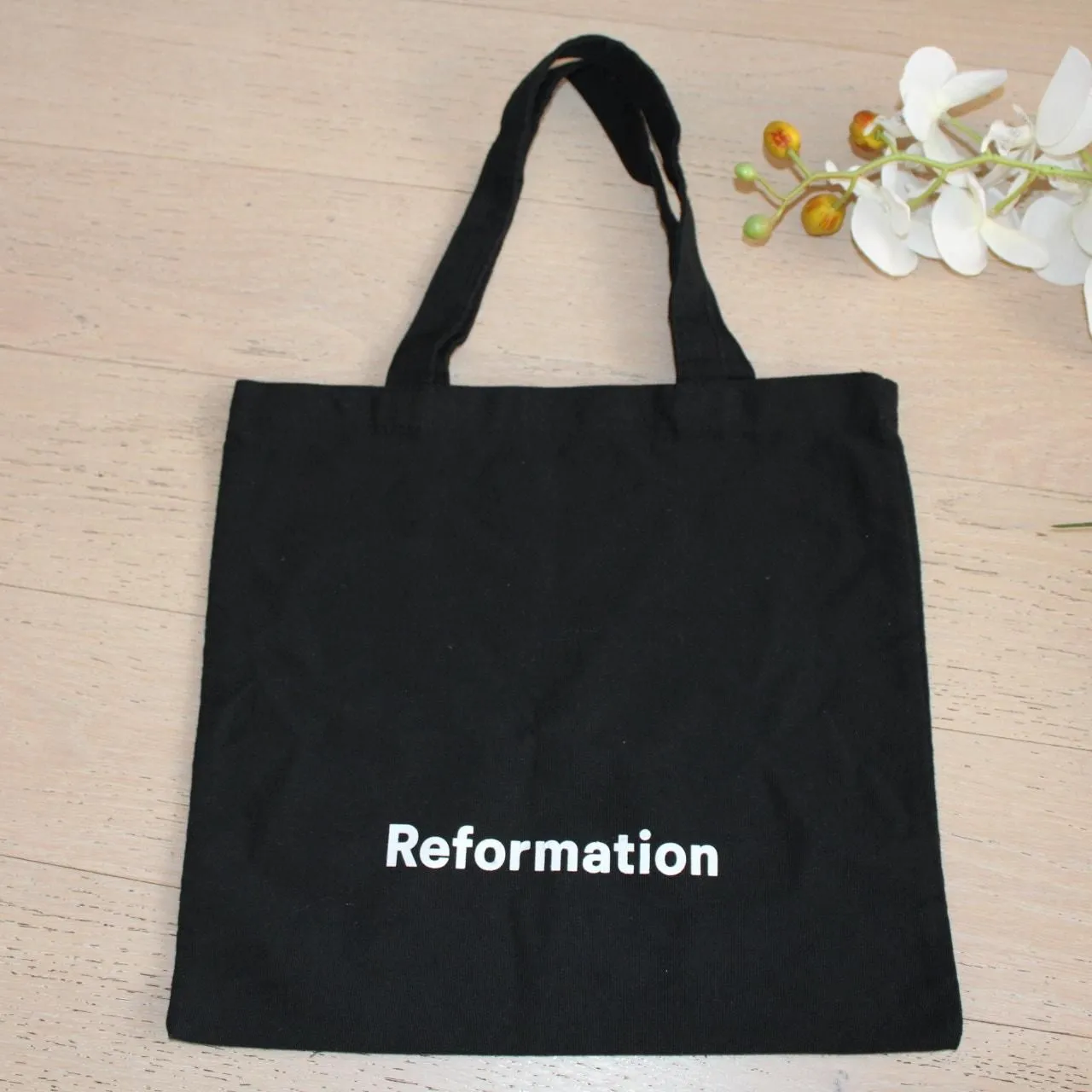 Product image for REFORMATION Canvas Tote Bag in Black with White Logo Print