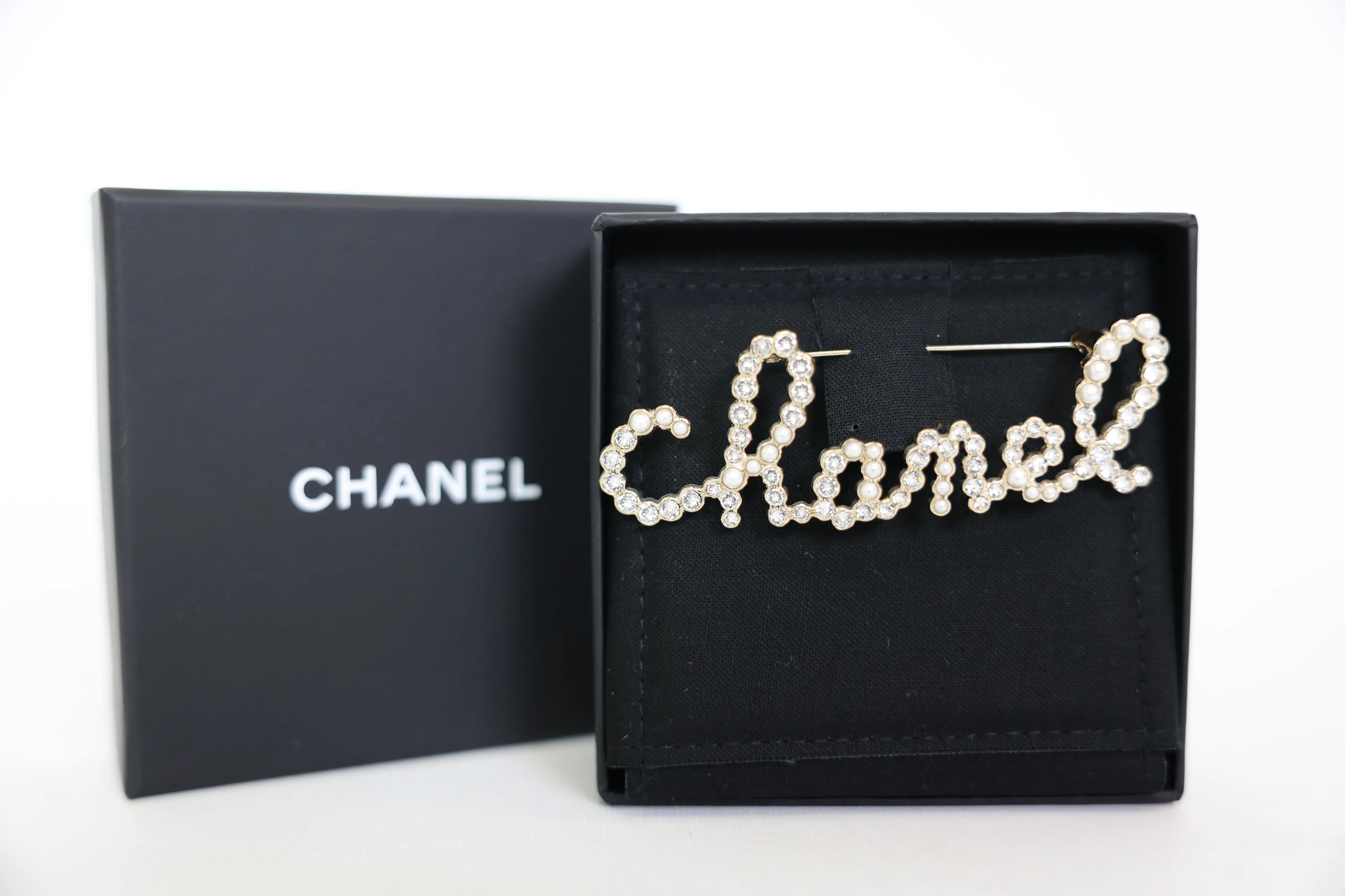Chanel cursive brooch hotsell