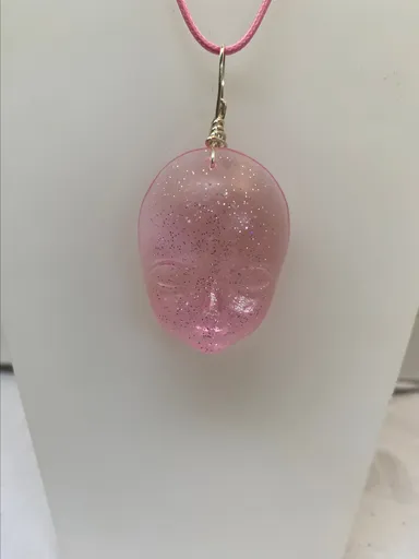 Resin pink face w/ glitter pendant.