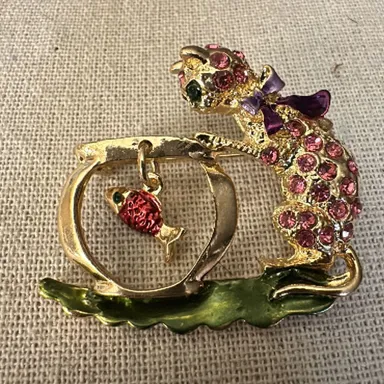 Pink Rhinestone Cat overlooking fish bowl with dangling fish brooch