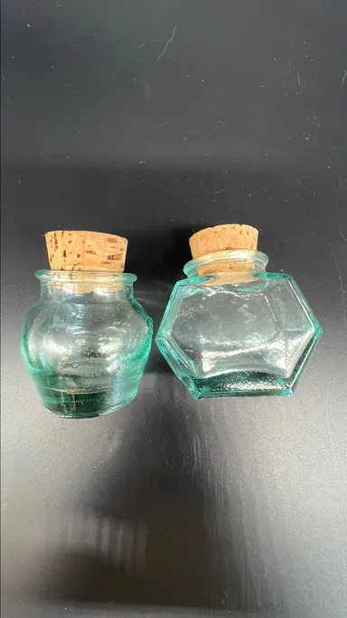 Two 2 inch bottles with corks.