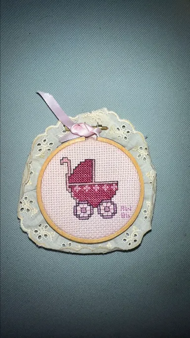 A baby carriage needlepoint with loom