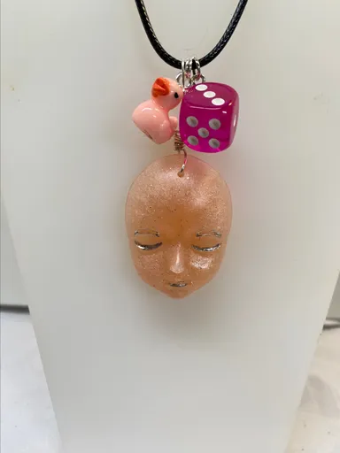 Resin light pink face w/ duck and dice pendant