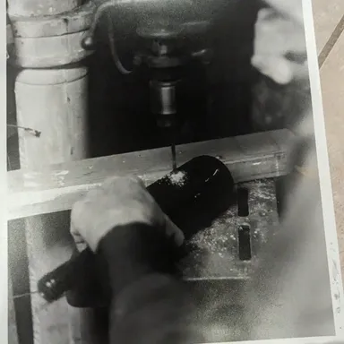 Man drilling Bottle - hand printed and retouched